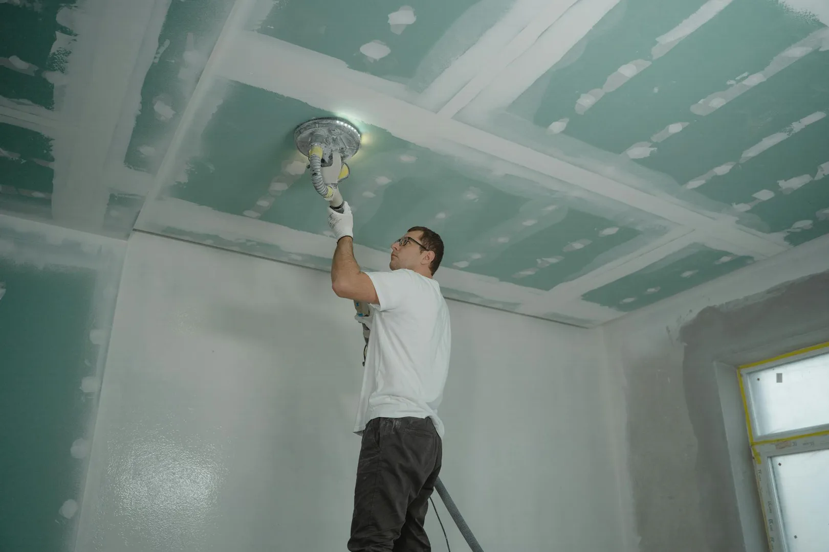 Professional drywall craftsman at work