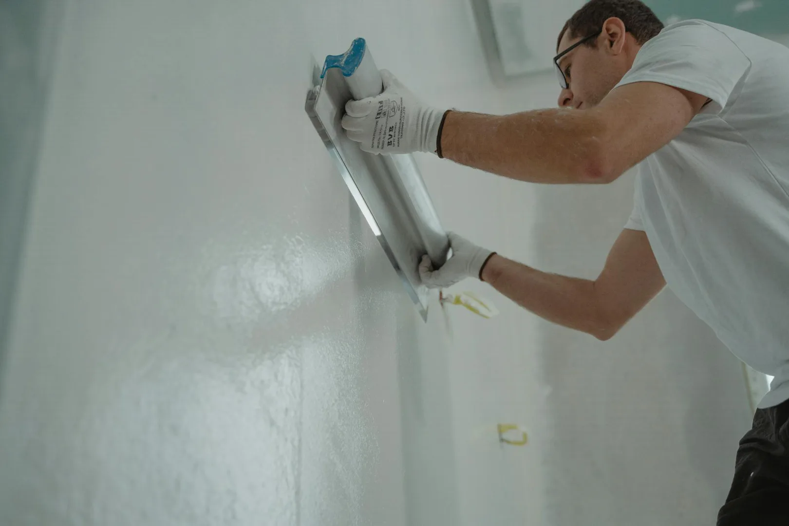 Professional drywall finishing in progress showing smooth wall surfaces